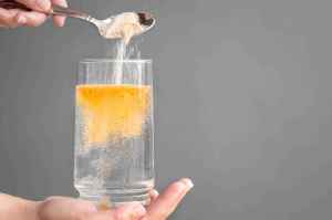 Orange electrolyte powder is mixed to make a drink